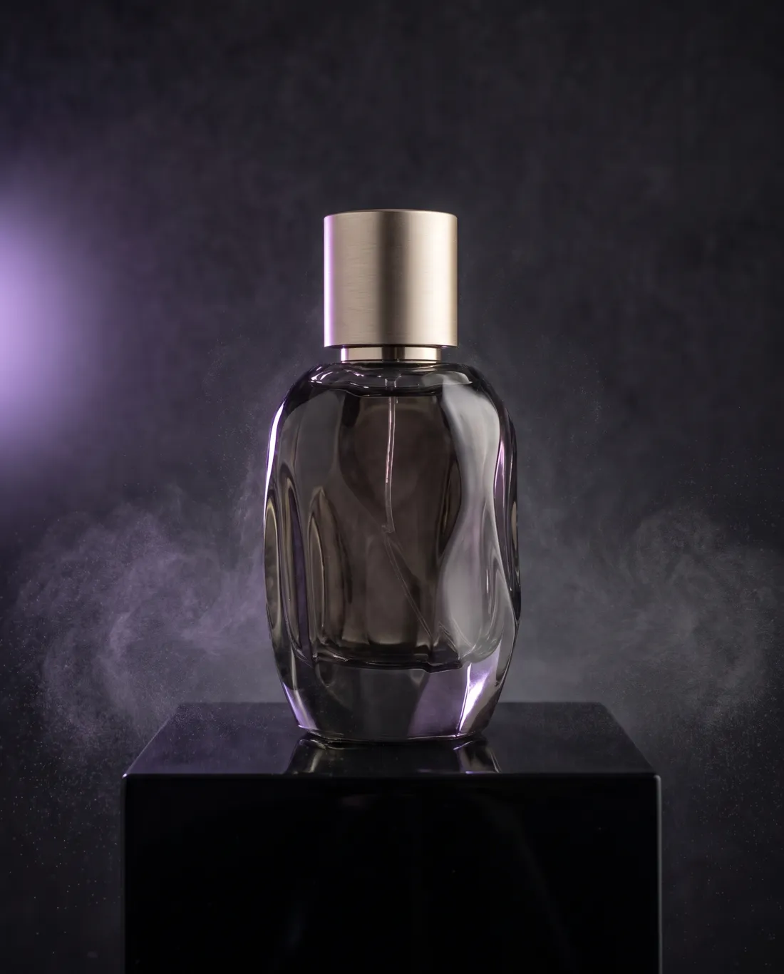 Concept example: smoked-glass fragrance bottle on black stone with violet rim light